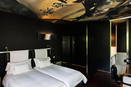 a bedroom with a bed with a painting on the ceiling at The Hotel Lucerne, Autograph Collection in Luzern