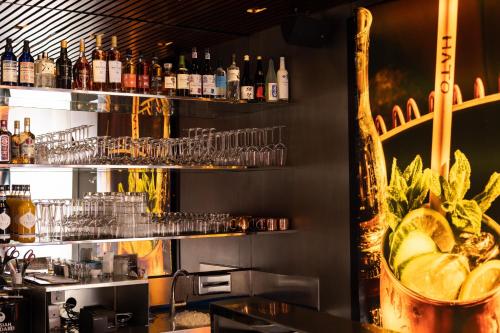 a bar with a lot of bottles and glasses at The Hotel Lucerne, Autograph Collection in Luzern