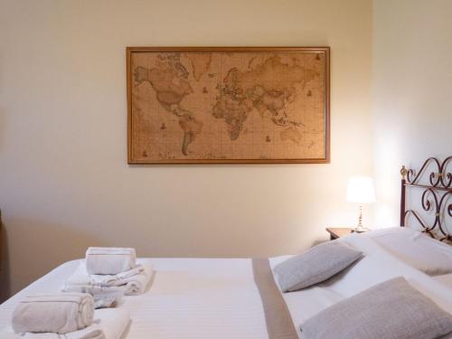 a room with a bed with a map on the wall at B&B Casa Decimo in Greve in Chianti