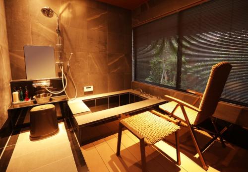 a desk and chair in a room with a window at yabenomori in Miyanoo