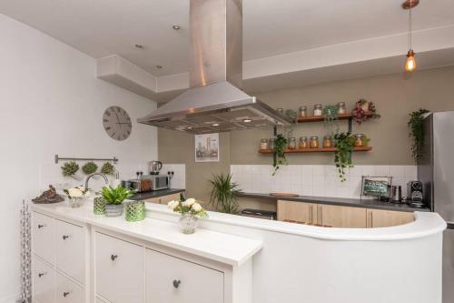 a kitchen with white cabinets and a counter top at Pass the Keys Shoppers Oasis - Heart of Leeds City Centre in Leeds