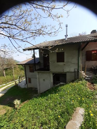 a house with its door open in a yard at Chalet Niki BELLAGIO in Bellagio