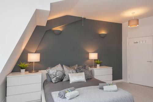 a bedroom with a large bed with two lamps at Pass the Keys Shoppers Oasis - Heart of Leeds City Centre in Leeds