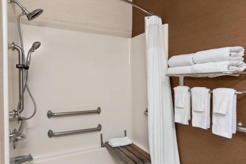 a bathroom with a shower and a tub with towels at Fairfield Inn & Suites Amarillo West/Medical Center in Amarillo