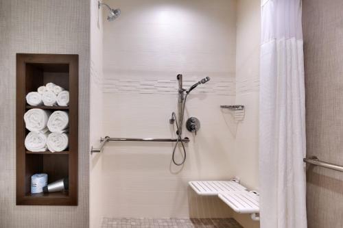 a bathroom with a shower with a toilet and towels at Residence Inn by Marriott Sedona in Sedona