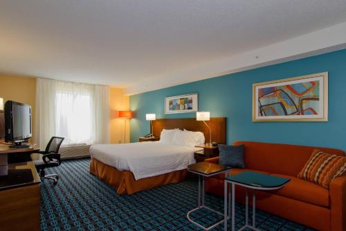 a hotel room with a bed and a couch at Fairfield Inn Hartsville in Hartsville