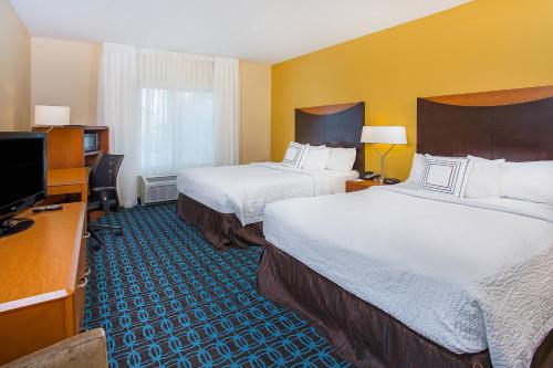 a hotel room with two beds and a flat screen tv at Fairfield Inn & Suites Cookeville in Cookeville