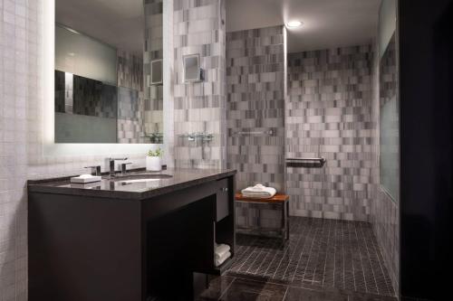 a bathroom with a sink and a mirror at The Ritz-Carlton, Los Angeles L.A. Live in Los Angeles