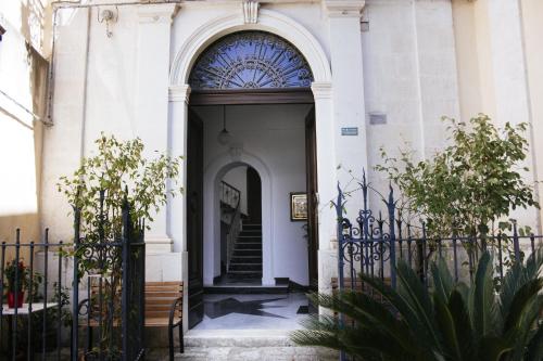 an entry to a building with a gate and stairs at Risveglio Ibleo in Ragusa