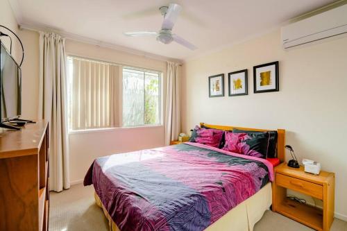 a bedroom with a bed and a window at Cosy Home in Yandina in Yandina