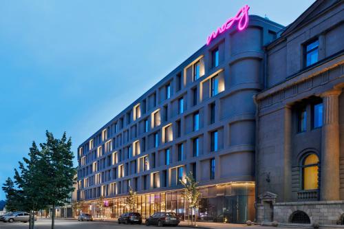 a building with a pink bow on top of it at Moxy Kaunas Center in Kaunas