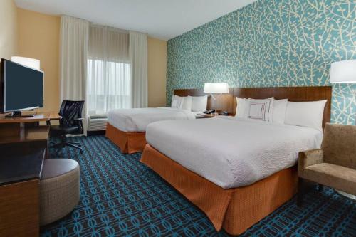 a hotel room with two beds and a television at Fairfield Inn & Suites by Marriott Fort Lauderdale Pembroke Pines in Pembroke Pines