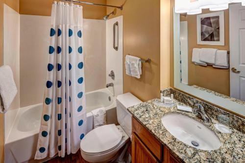 a bathroom with a sink and a toilet and a shower at TownePlace Suites Dallas Las Colinas in Irving