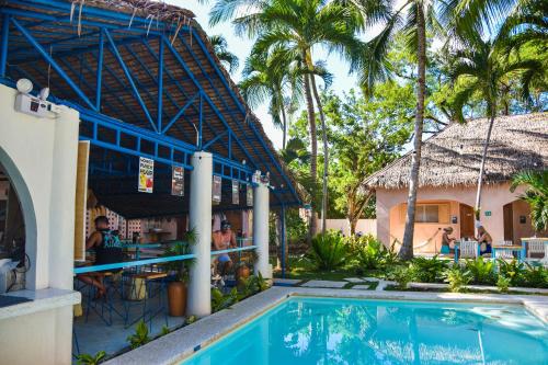 a resort with a swimming pool and a restaurant at Mad Monkey Panglao in Panglao
