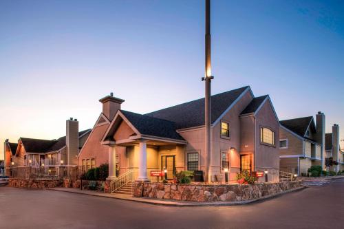 a large house with a flag on a street at Residence Inn Denver Downtown in Denver