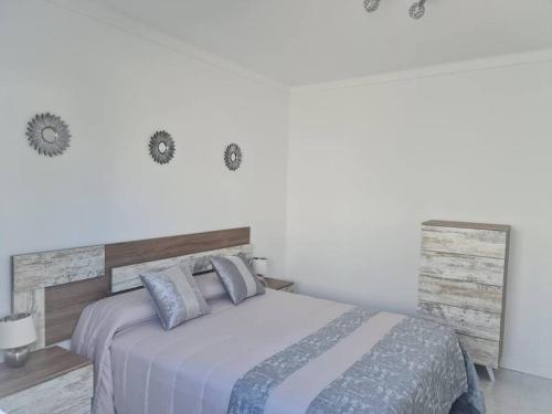 a bedroom with a large bed with a wooden headboard at Villa Toledo in Tías