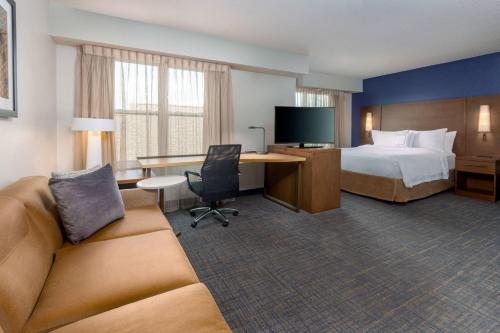 a hotel room with a bed and a desk at Residence Inn by Marriott Boston Brockton/Easton in Brockton