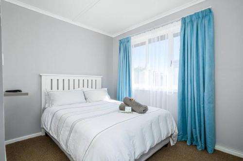 a bedroom with a bed with a teddy bear on it at The Slipway in Colchester