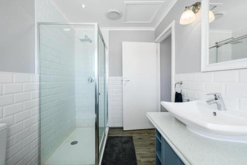 a bathroom with a glass shower and a sink at The Slipway in Colchester