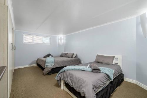 two beds in a room with white walls at The Slipway in Colchester