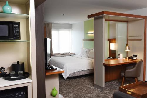 a hotel room with a bed and a desk at SpringHill Suites by Marriott Sioux Falls in Sioux Falls