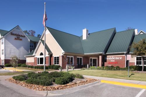 a building with an american flag in front of it at Residence Inn Houston The Woodlands/Market Street in The Woodlands