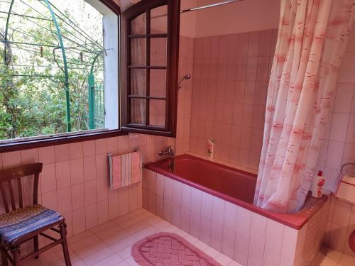 a bathroom with a red tub and a window at Villa avec piscine privée in Allauch