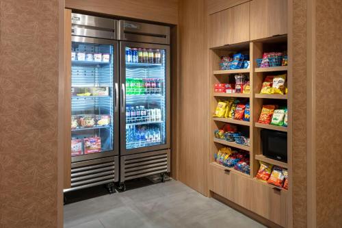 a kitchen with a refrigerator with food and drinks at Fairfield Inn & Suites by Marriott Atlanta Marietta in Marietta