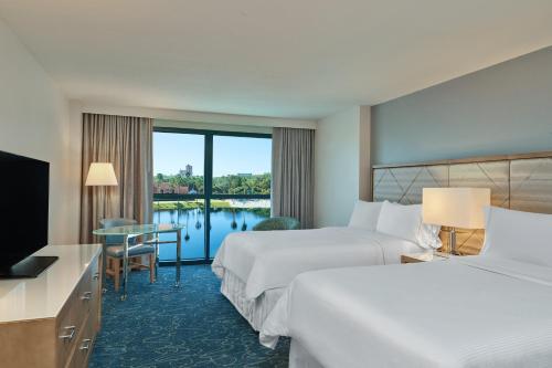 a hotel room with two beds and a view of a lake at Walt Disney World Dolphin in Orlando