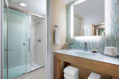 a bathroom with a sink and a glass shower at Walt Disney World Dolphin in Orlando