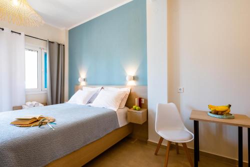 a bedroom with a bed and a desk and a chair at Pargabella apartments in Parga