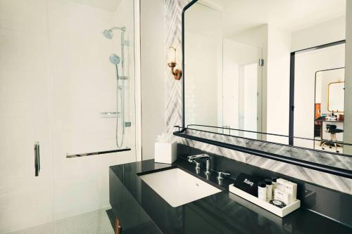 a bathroom with a sink and a mirror at The Draftsman, Autograph Collection in Charlottesville