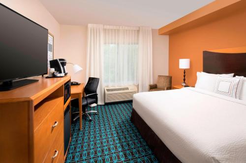 a hotel room with a bed and a flat screen tv at Fairfield Inn & Suites-Washington DC in Washington