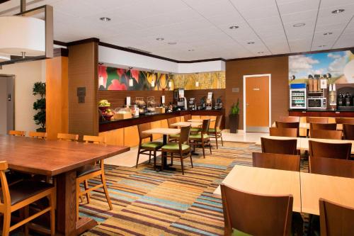 a restaurant with tables and chairs and a bar at Fairfield Inn & Suites-Washington DC in Washington, D.C.