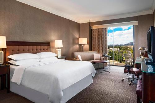 a bedroom with a large white bed and a window at Sheraton Phoenix Crescent in Phoenix