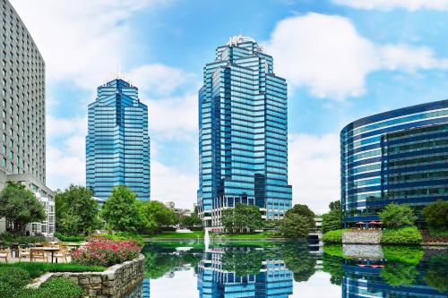 two tall buildings next to a river in a city at The Westin Atlanta Perimeter North in Atlanta