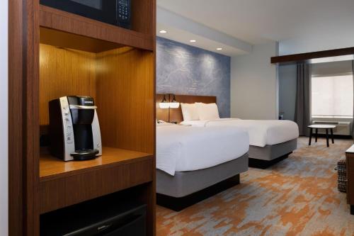 a hotel room with a bed and a tv at Fairfield Inn & Suites by Marriott Moab in Moab