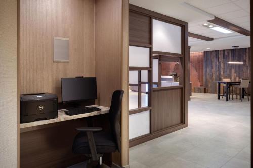an office with a desk with a computer and a chair at Fairfield Inn & Suites by Marriott Moab in Moab