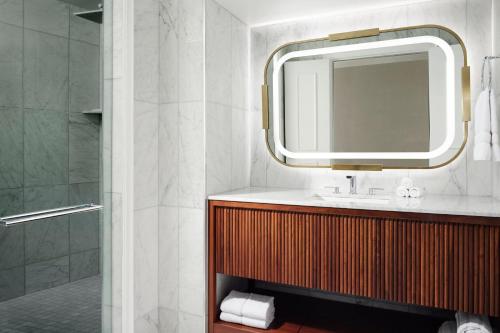 a bathroom with a sink and a mirror and a shower at The Westin Philadelphia in Philadelphia