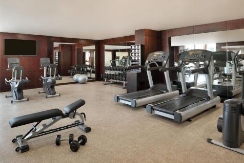 a gym with several treadmills and exercise machines at Marriott Executive Apartments Manama, Bahrain in Manama