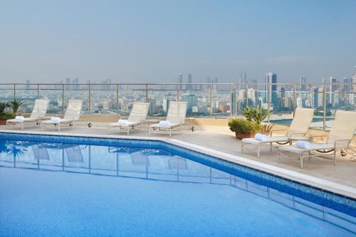 a swimming pool on the roof of a building at Marriott Executive Apartments Manama, Bahrain in Manama