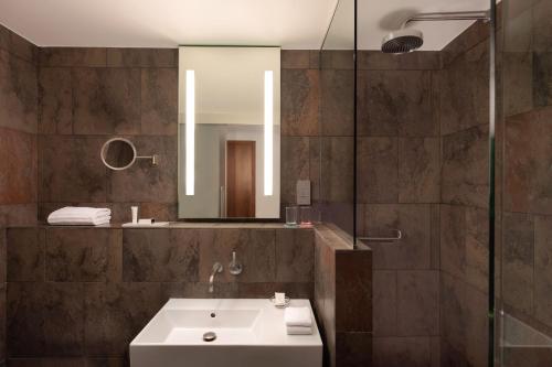 a bathroom with a sink and a mirror at Le Meridien Barcelona in Barcelona