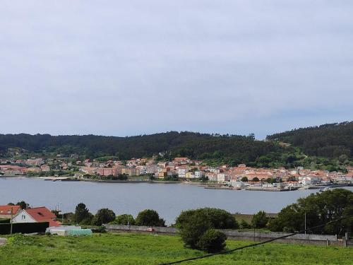 a view of a large body of water with houses at SOLPOR in Cee