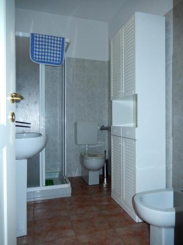 a bathroom with a sink and a toilet and a shower at Appartamento Porto 2 in Cannero Riviera