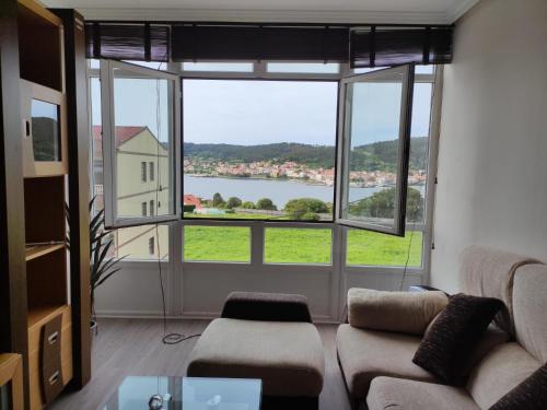 a living room with a large window with a view at SOLPOR in Cee