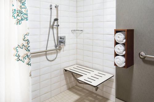 a bathroom with a shower with a bench in it at Residence Inn by Marriott Boston Woburn in Woburn