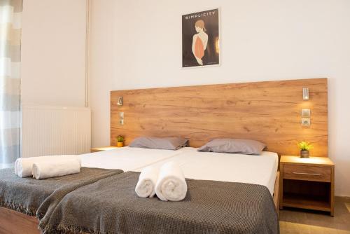 two beds with towels on them in a bedroom at Tony's Garden House in Lefkimmi
