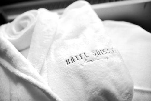 a white towel with the word littleshock written on it at Hotel Suisse in Strasbourg