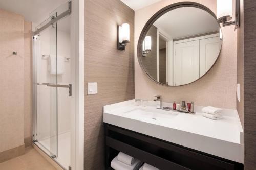 a bathroom with a sink and a mirror at Colorado Springs Marriott in Colorado Springs