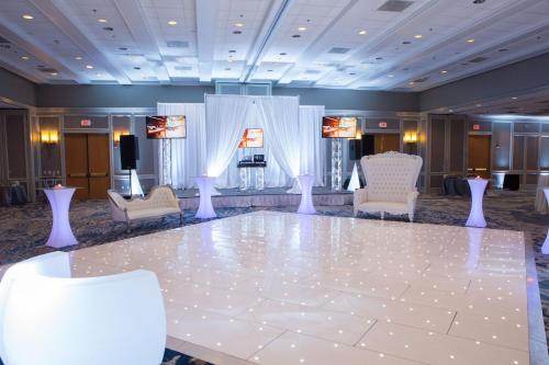 a ballroom with a large white dance floor at Boston Marriott Newton in Newton